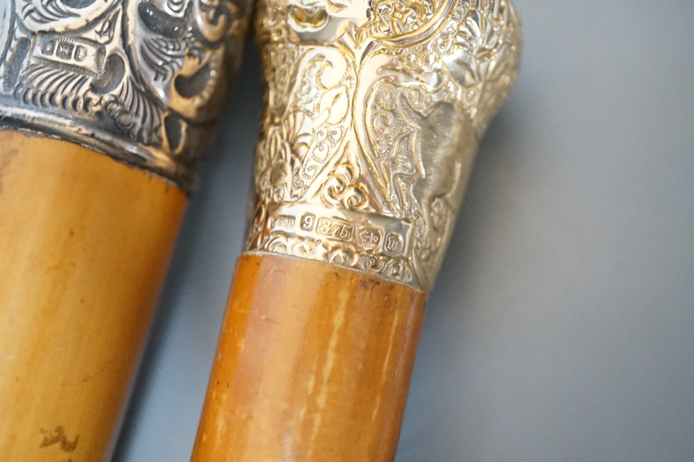 Two 19th century malacca walking canes: one with an Indian inspired 9ct gold handle, the other with a silver embossed handle, gold handled cane 92 cms long